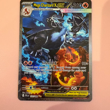 Pokémon trading card featuring Mega Charizard X on a peach-colored background