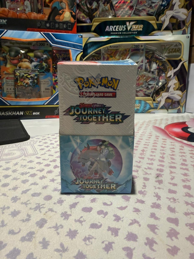 Pokémon trading card game box with 'Journey Together' on a patterned surface